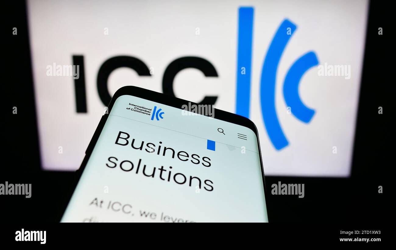 Smartphone with website of organisation International Chamber of Commerce (ICC) in front of logo. Focus on top-left of phone display. Stock Photo