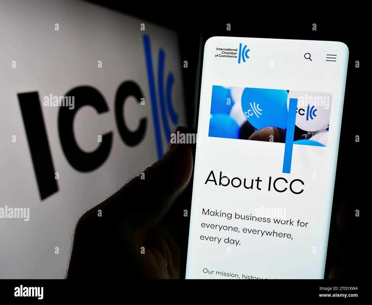 Person holding cellphone with webpage of organisation International Chamber of Commerce (ICC) in front of logo. Focus on center of phone display. Stock Photo