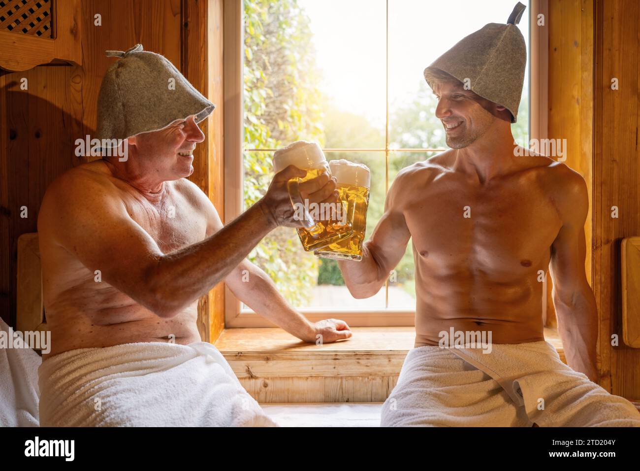 happy german men in finnish sauna wearing felt hats toasting withgerman
