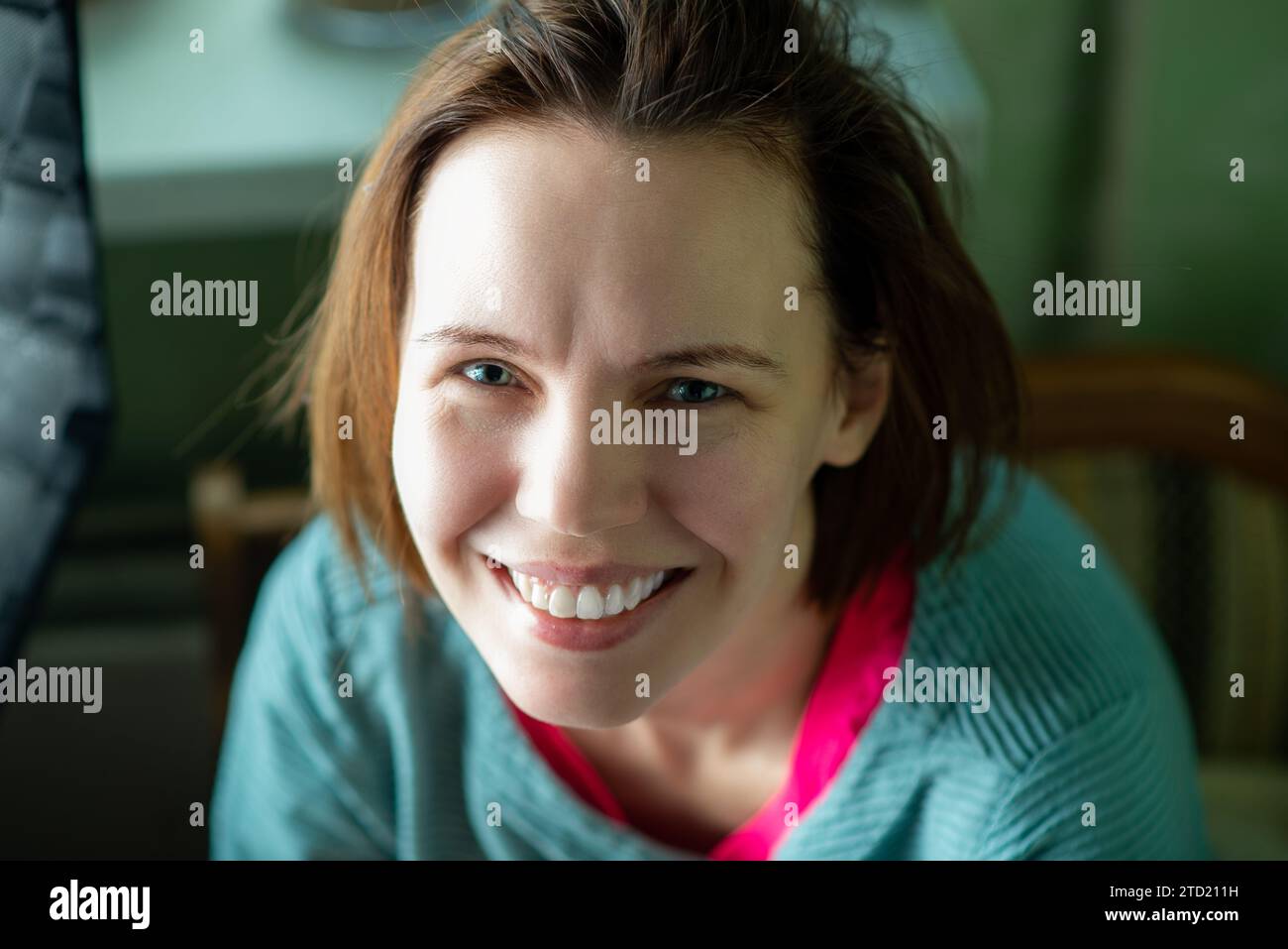 Happy smiling middle aged woman, forty years old. Ordinary woman without make-up at home. Stock Photo