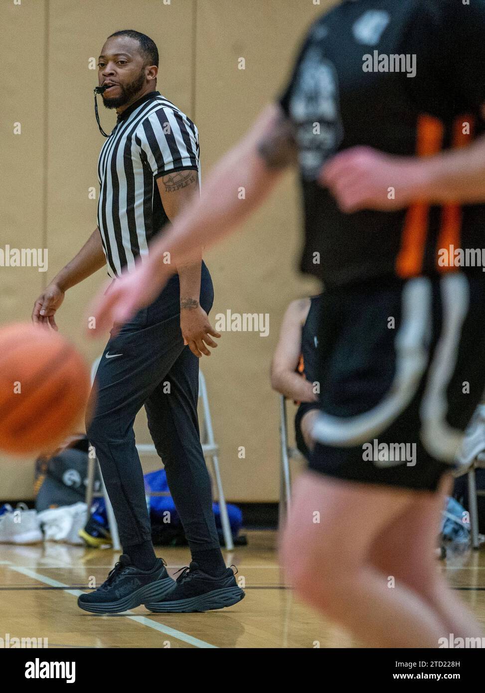 African American basketball referee at a high school game Stock Photo