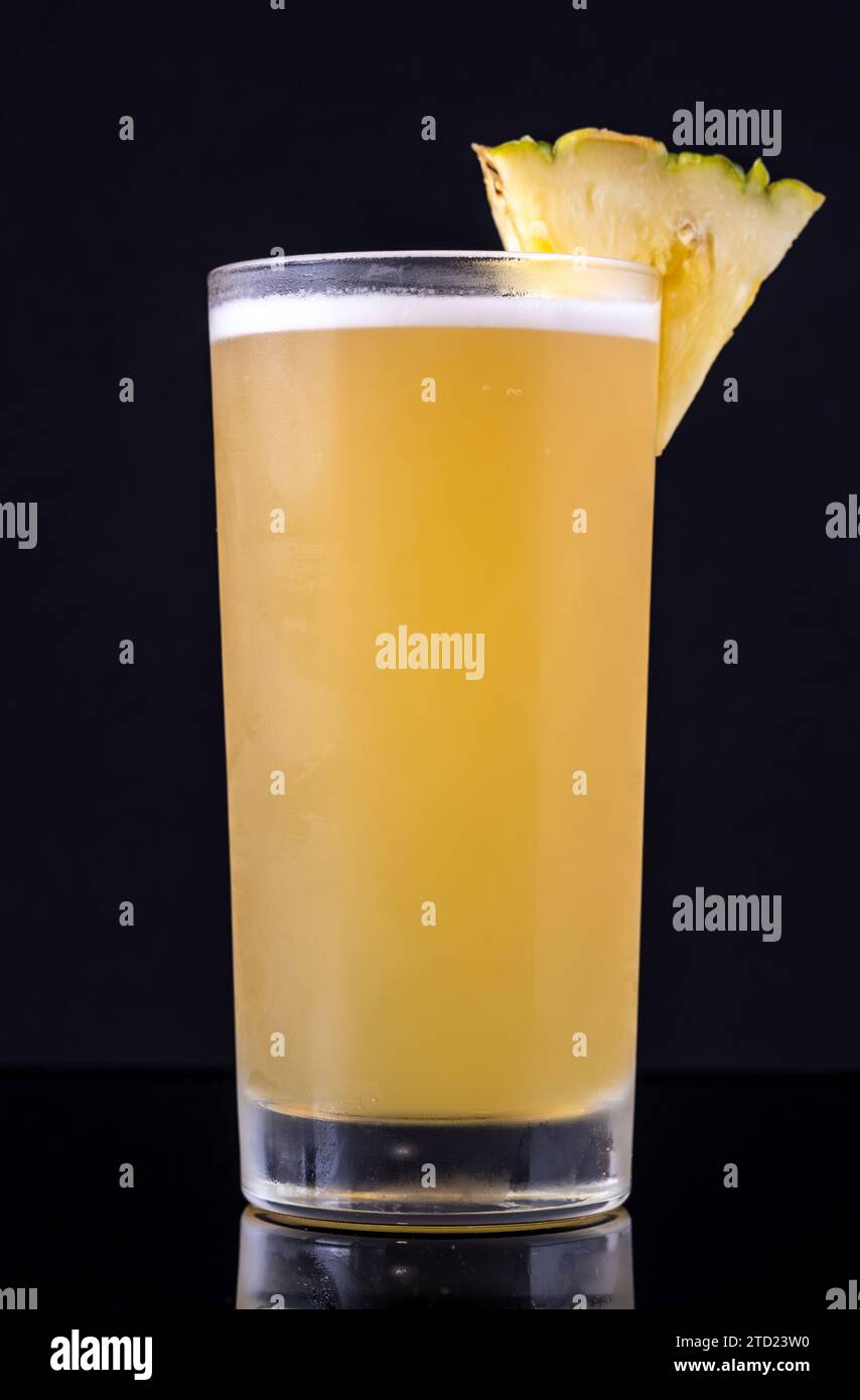 Pineapple Lemon Crush cocktail garnished with pineapple wedge Stock