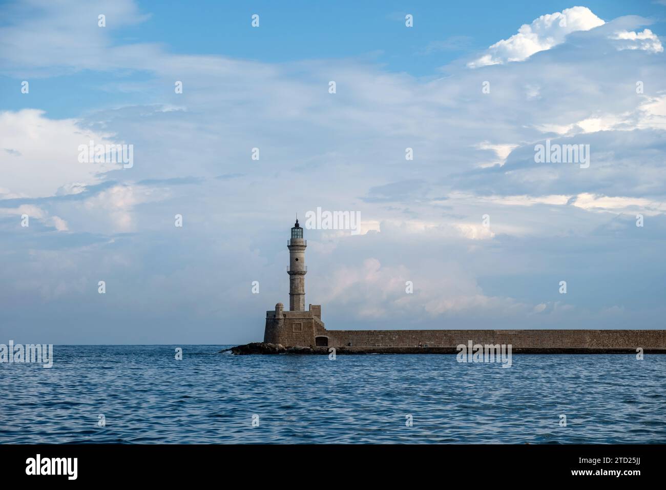 Crete island, Greece. Lighthouse, beacon at Venetian harbour in Old Town of Chania, cloudy sky Stock Photo