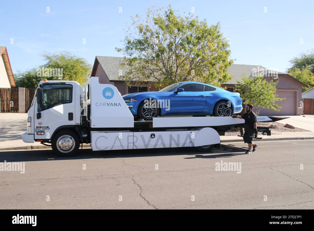 A Carvana Representative Moves A Car Sold On the spot Onto A Flatbed a-carvana-representative-moves-a-car-sold-on-the-spot-onto-a-flatbed