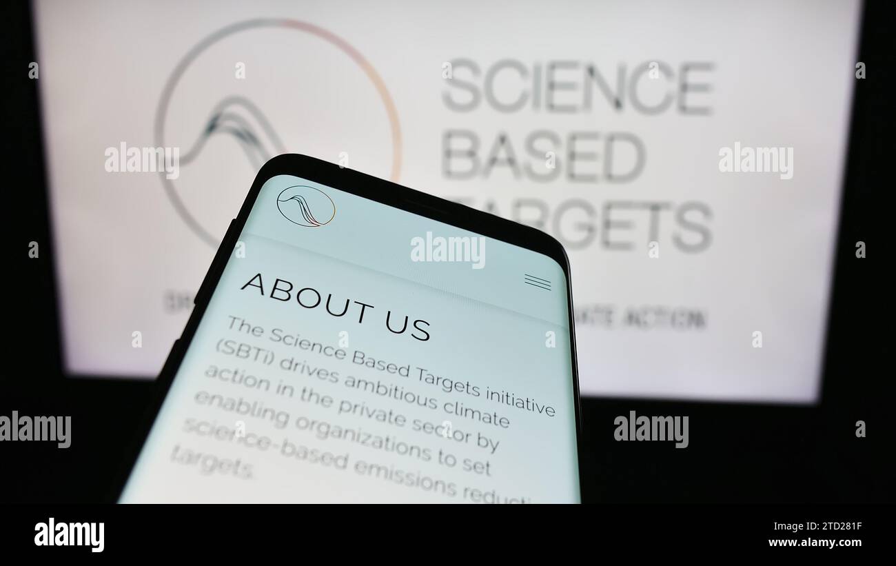 Mobile phone with website of organisation Science Based Targets initiative (SBTi) in front of logo. Focus on top-left of phone display. Stock Photo