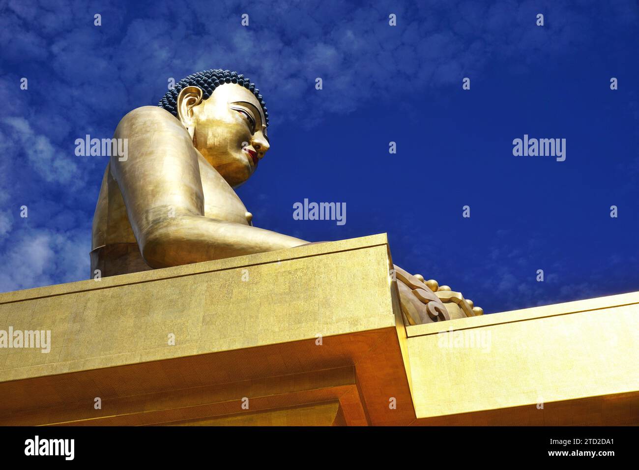 The golden Buddha Dordenma statue silhouetted against blue sky in the Kuensel Phodrang nature park overlooking the entrance to Thimphu Valley, Bhutan. Stock Photo