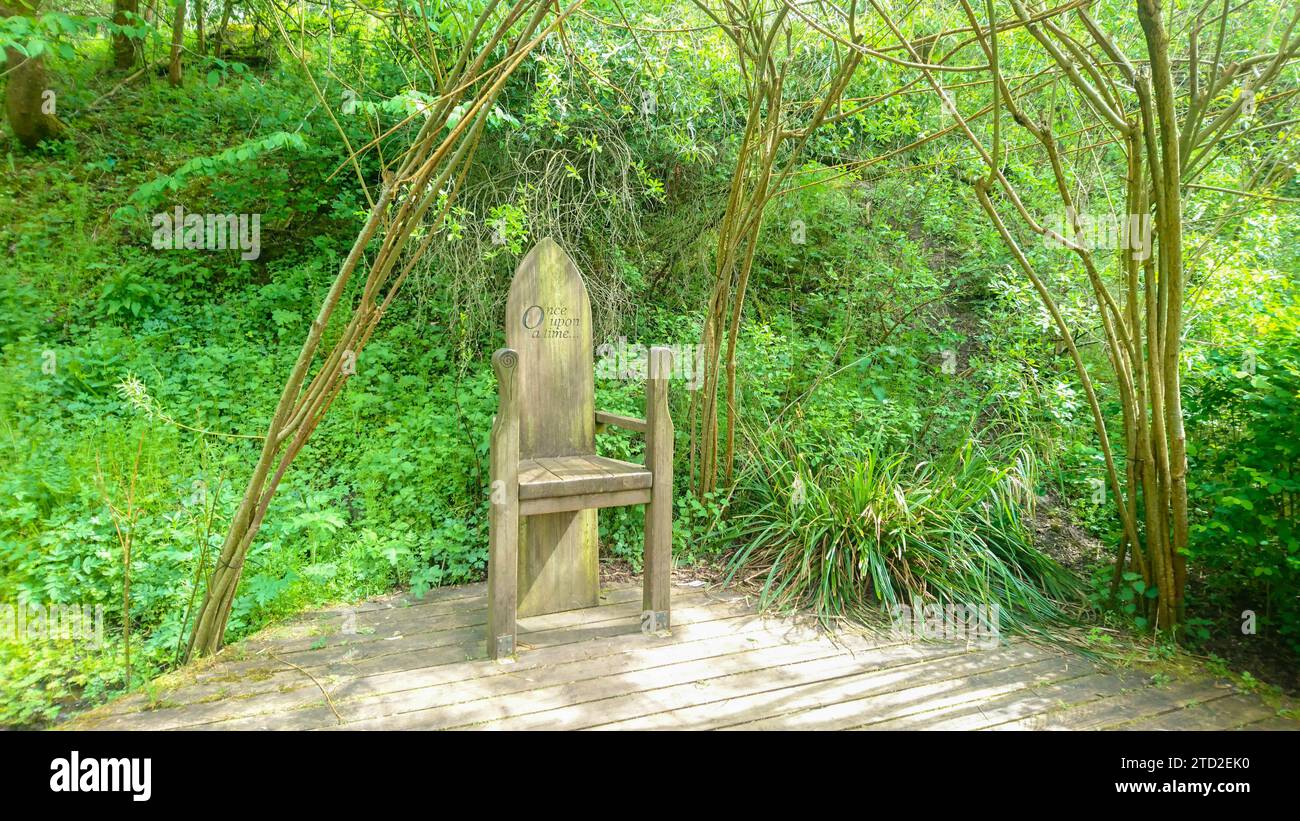 Wooden chair in shape of throne with engraving located in children playground in New Lanark world heritage site Stock Photo