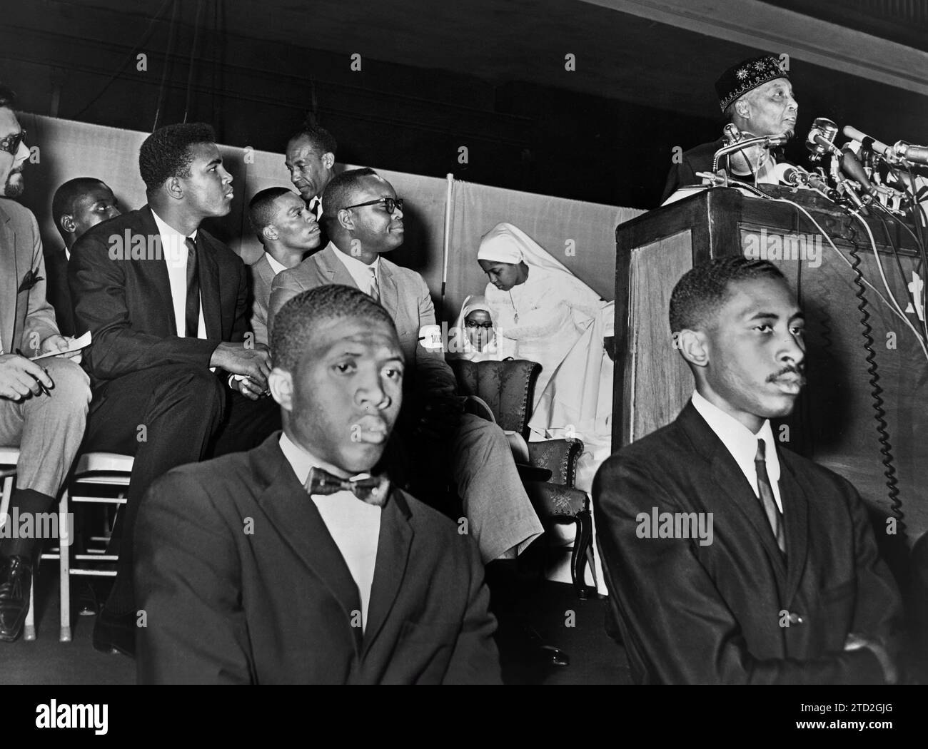 Elijah Muhammad addressing followers including Cassius Clay, Stanley