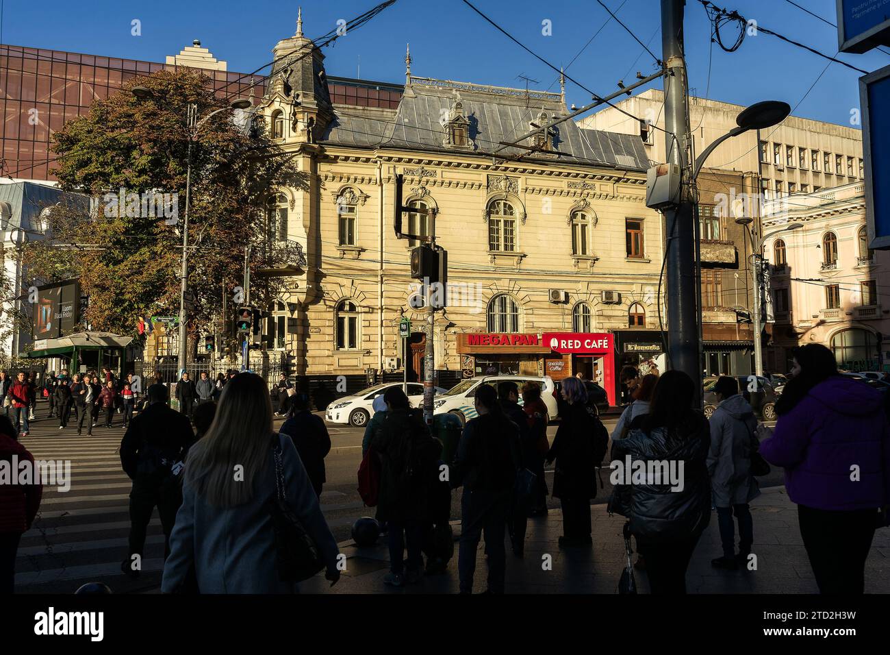 Bucharest, Romania - November 14, 2023: People wait to cross the street in Roman Square. This image is for editorial use only. Stock Photo