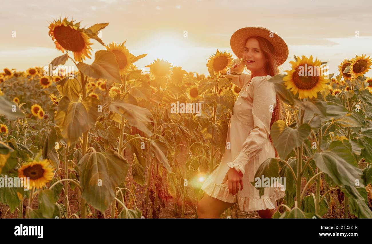Woman in Sunflower Field: Happy girl in a straw hat posing in a vast ...