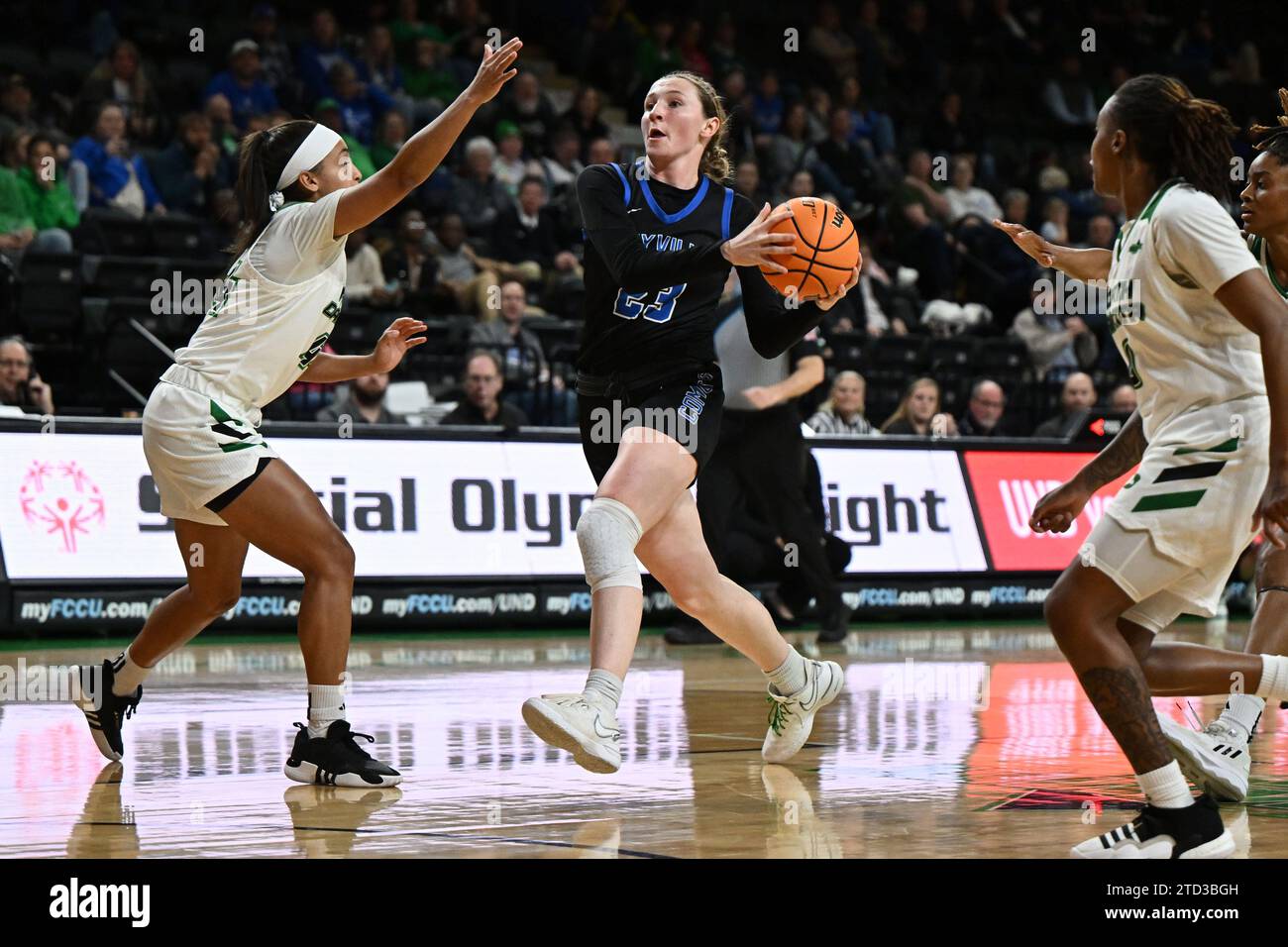 Mayville State Comets Guard Jordan Zrust (23) drives to the basket