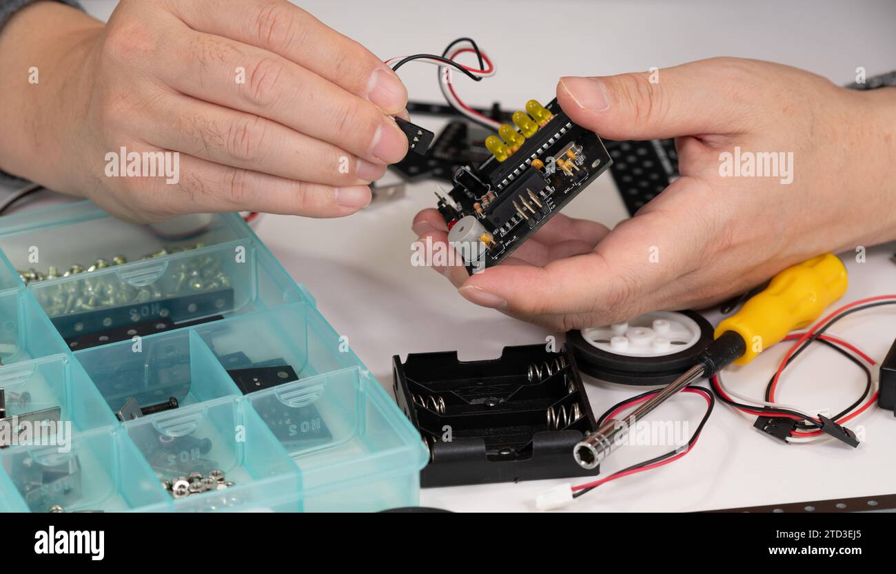 Close-up of hands assembling robotics educational toy. STEM education concept Stock Photo