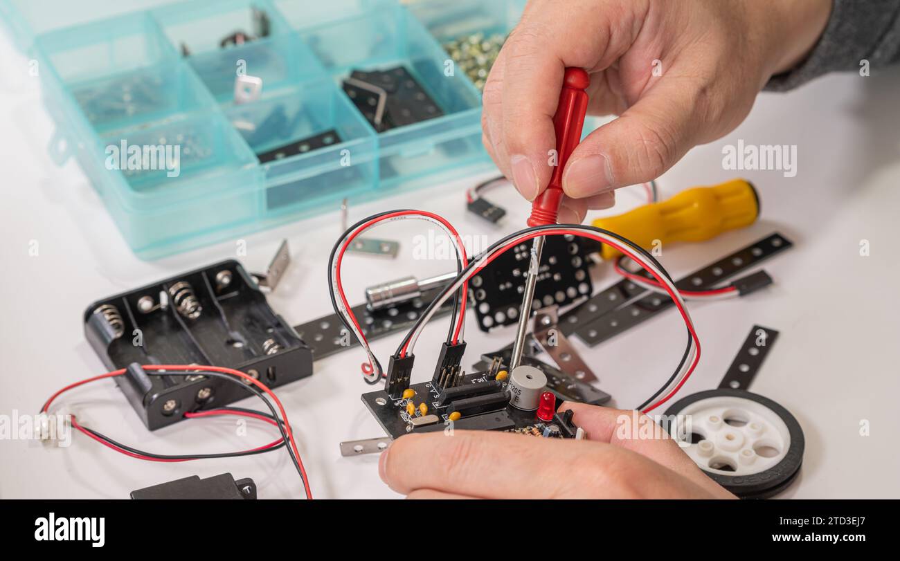 Close-up of hands assembling robotics educational toy. STEM education concept Stock Photo