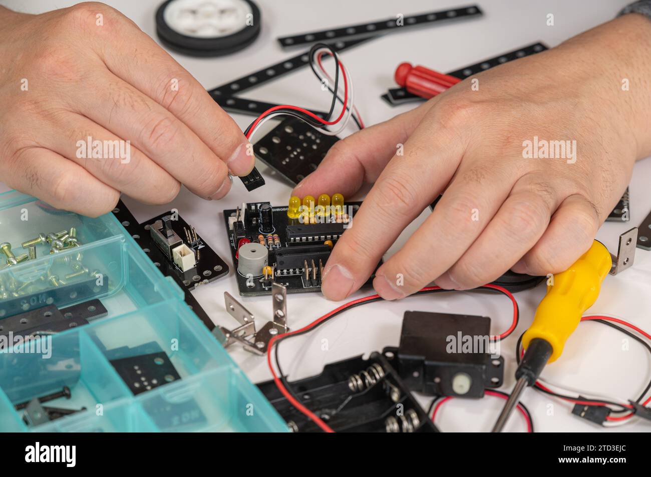 Close-up of hands assembling robotics educational toy. STEM education concept Stock Photo