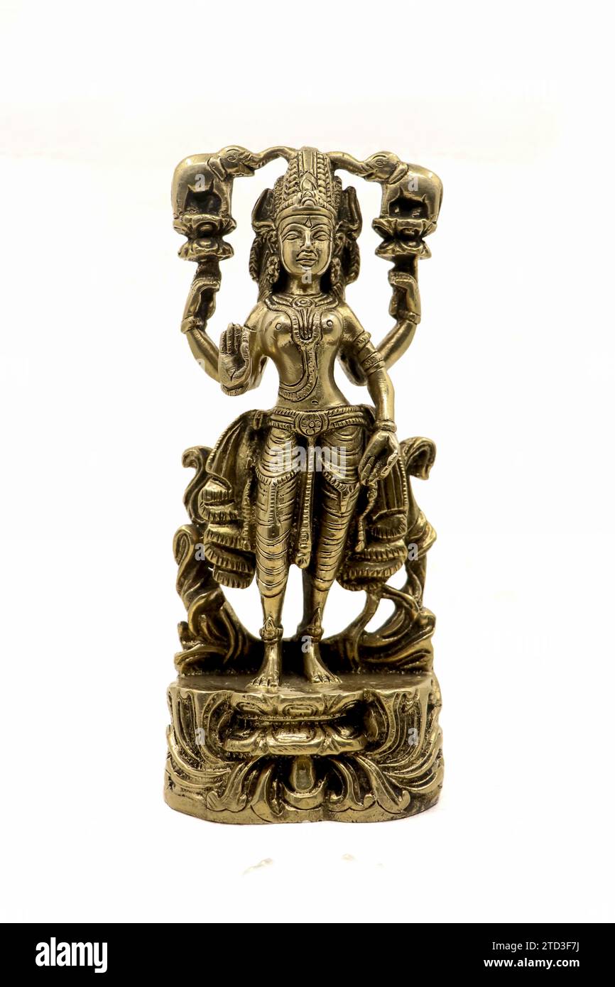 vintage figure of an angel from ancient indian temple handcrafted in gold material isolated in a white background Stock Photo