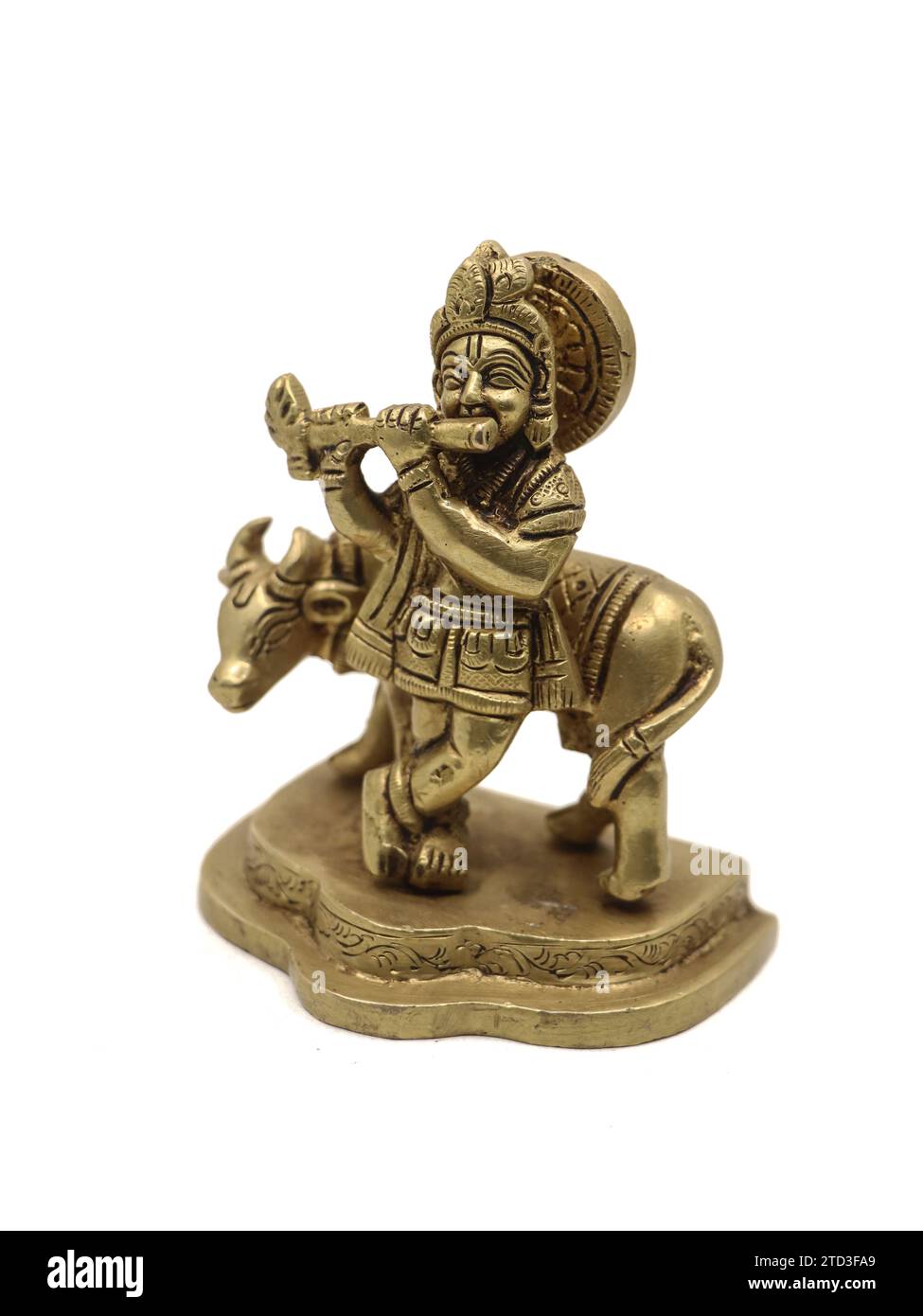 vintage lord krishna statue playing flute music beside a cow, a vishnu avatar isolated in a white background Stock Photo