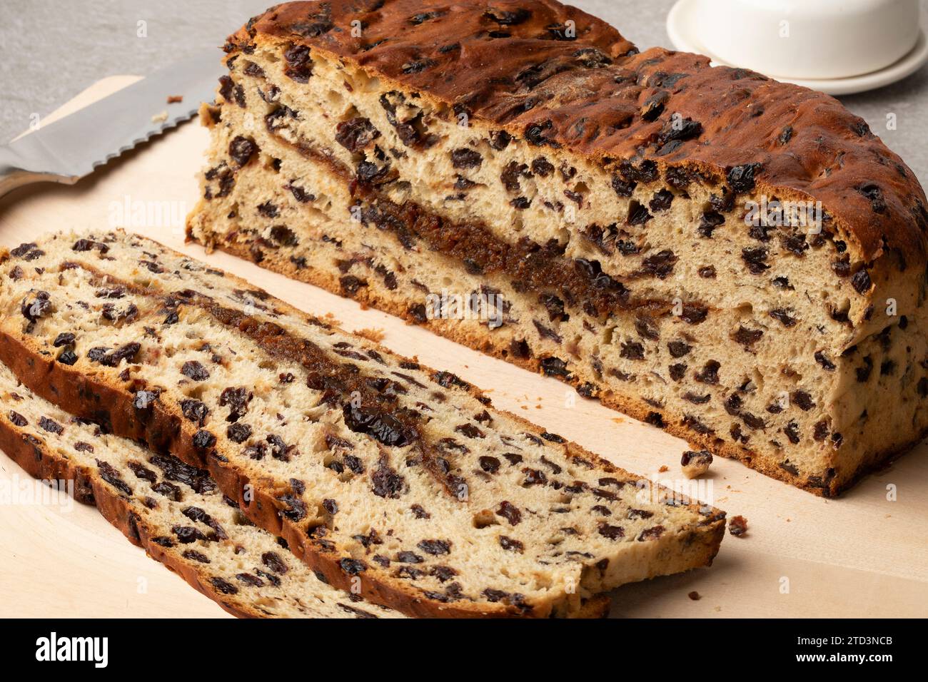 Fresh homemade traditional Dutch Currant bread and cinnamon sugar, Krentenwegge, and slices close up Stock Photo