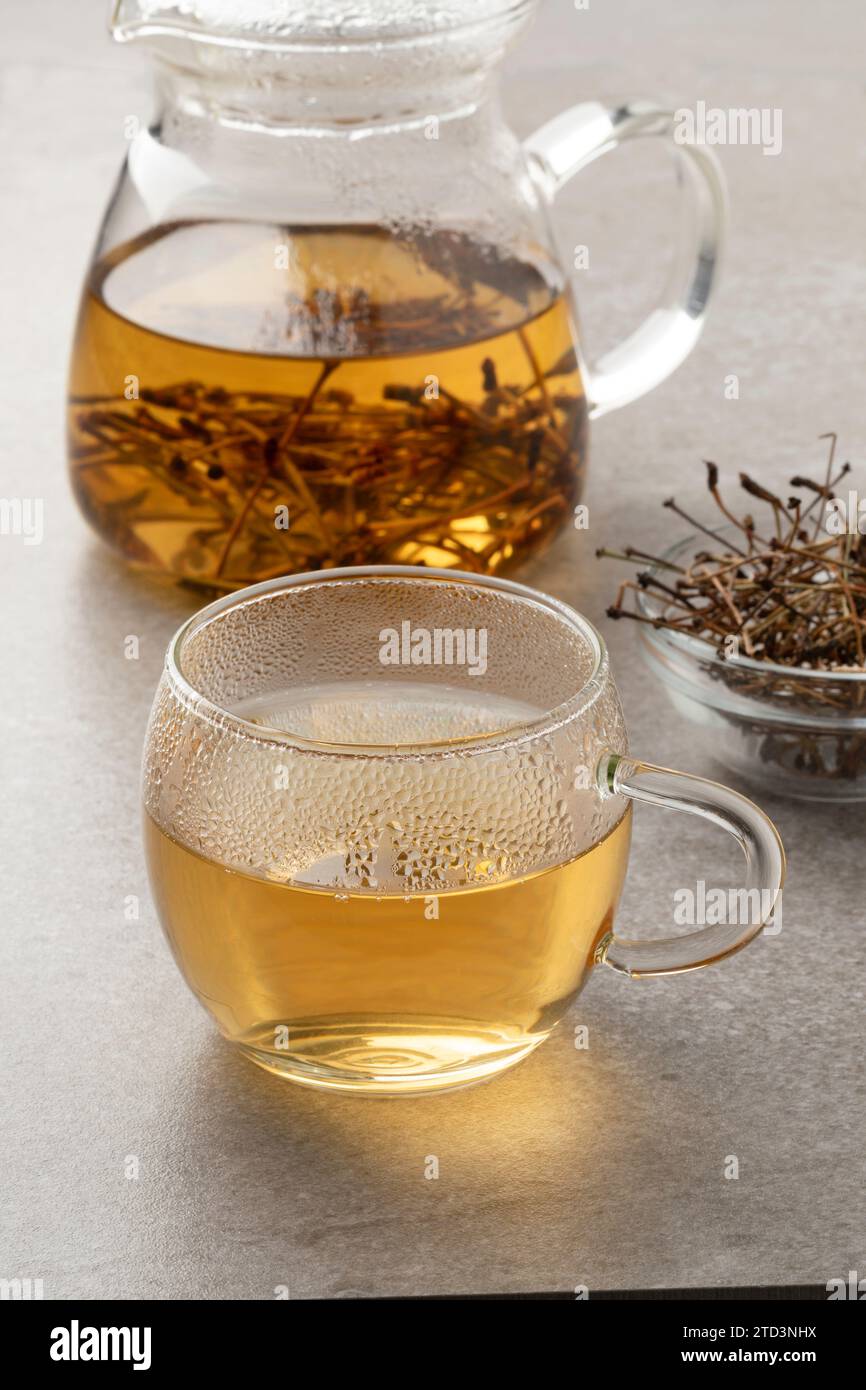 Glass cup with tea made from dried cherry stalks close up Stock Photo