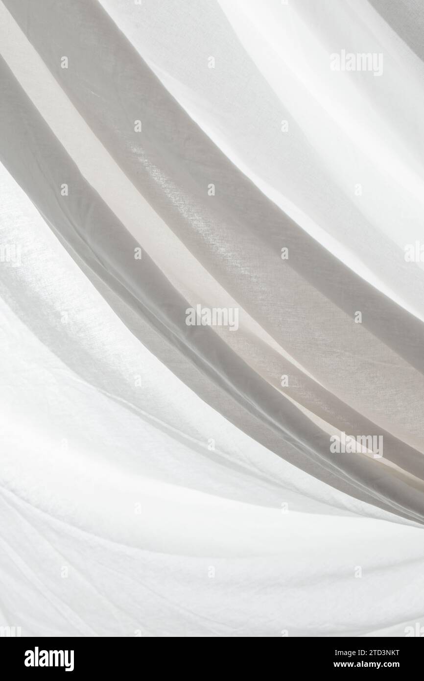 white fabric curtain creases back lit, soft focus close up Stock Photo