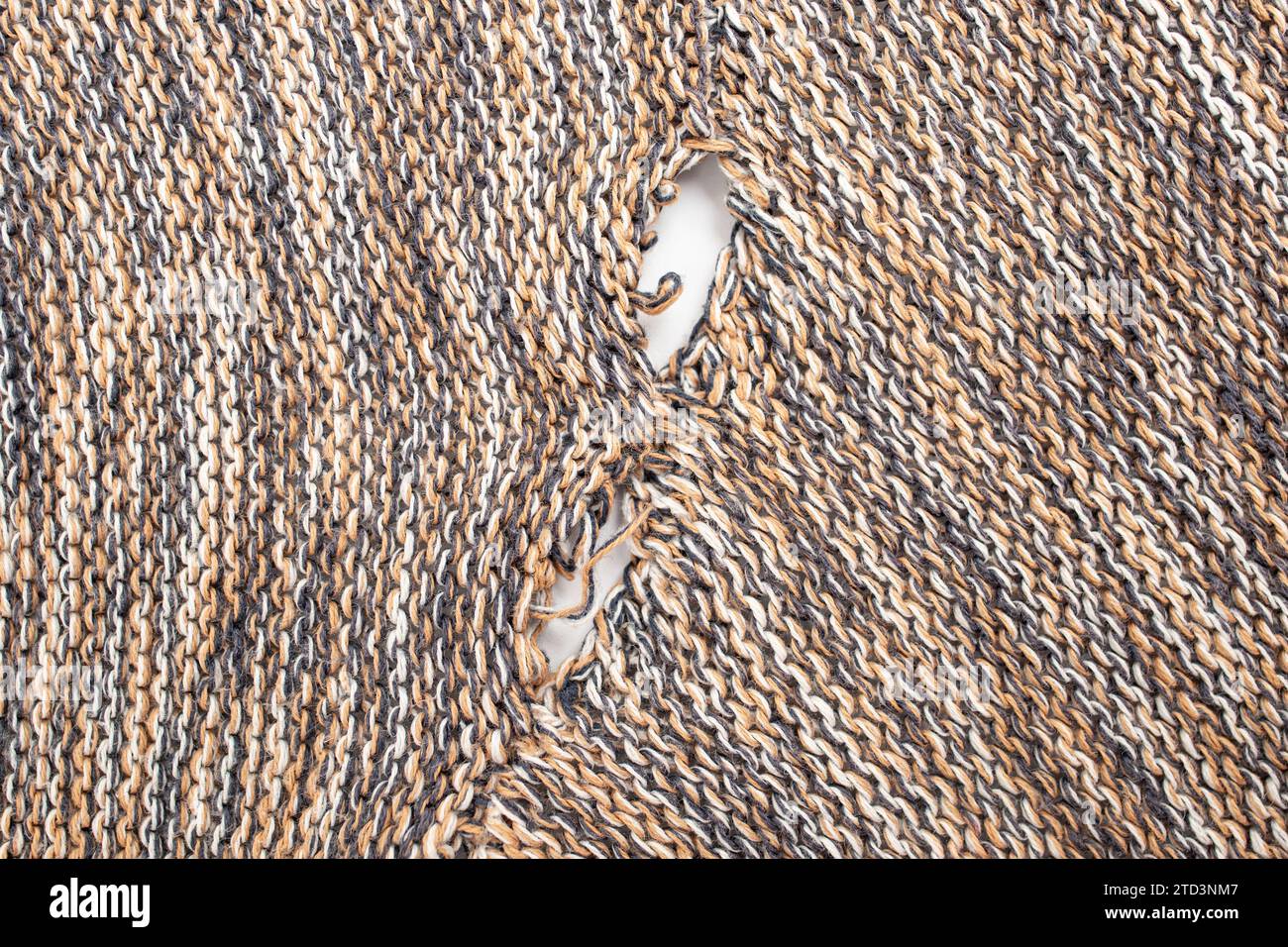 ripped pullover fabric that needs repair, repurposing concept, close up Stock Photo