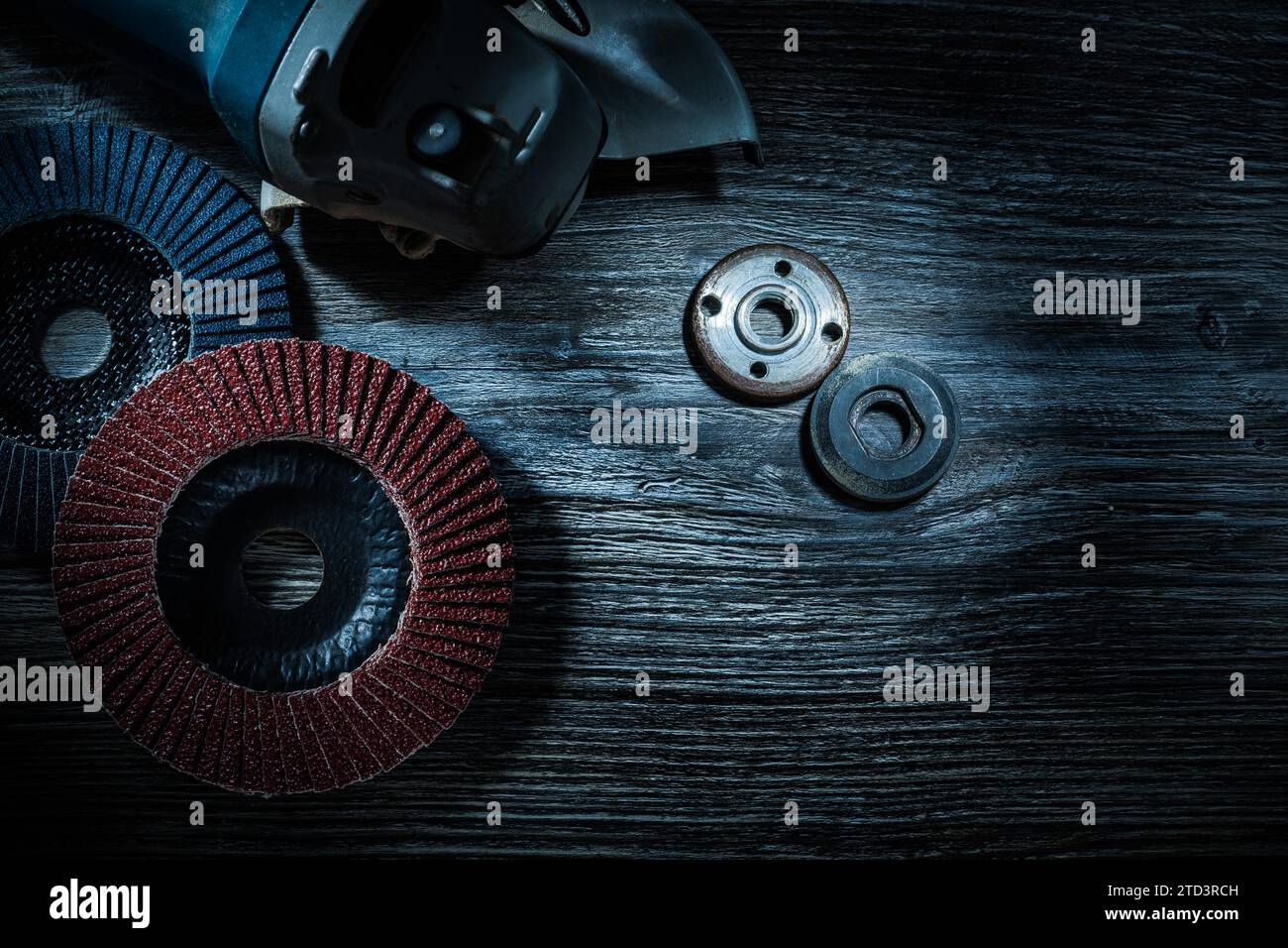Hand angle grinder radial abrasive discs on vintage wooden board Stock Photo