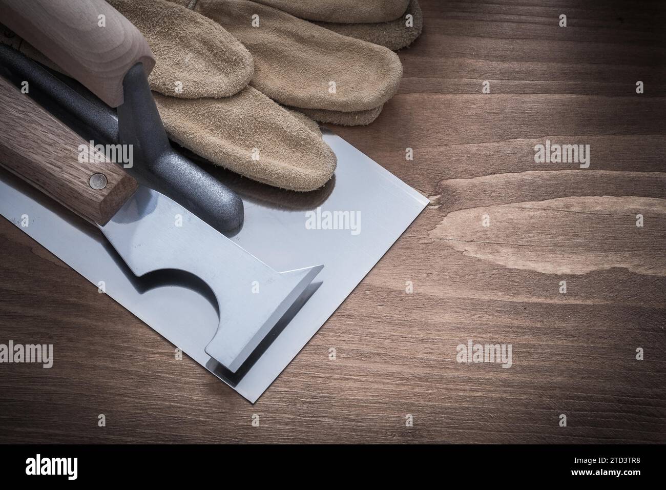 Spatula, plastering trowel and leather protective gloves Construction concept Stock Photo
