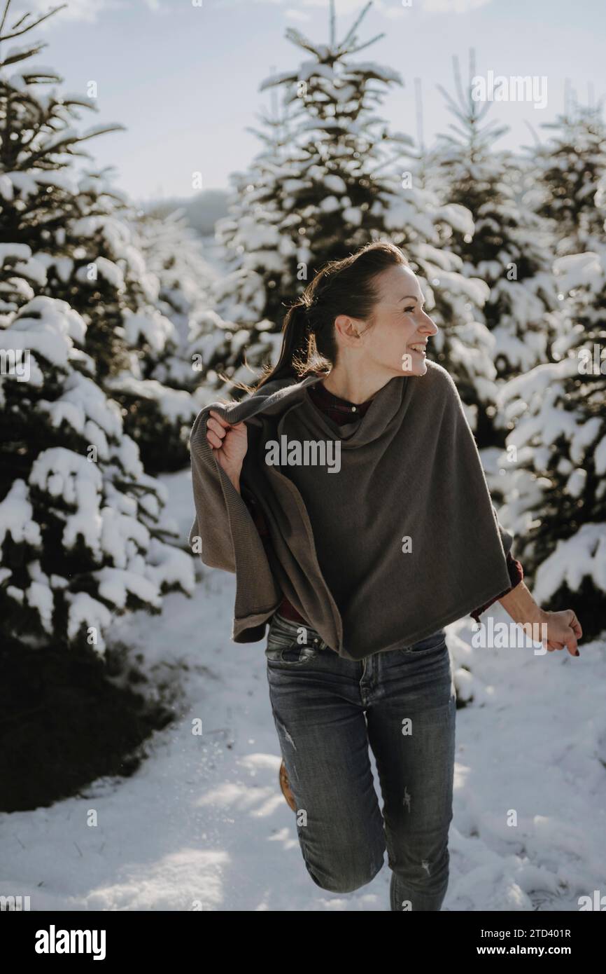 Woman in a poncho in a snowy landscape Stock Photo
