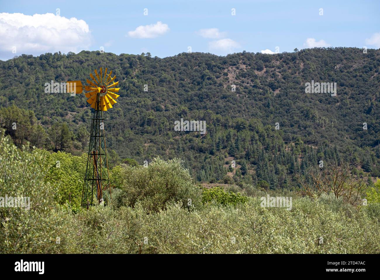 Windmill to produce electricity on a farm in the agricultural fields of Spain Stock Photo