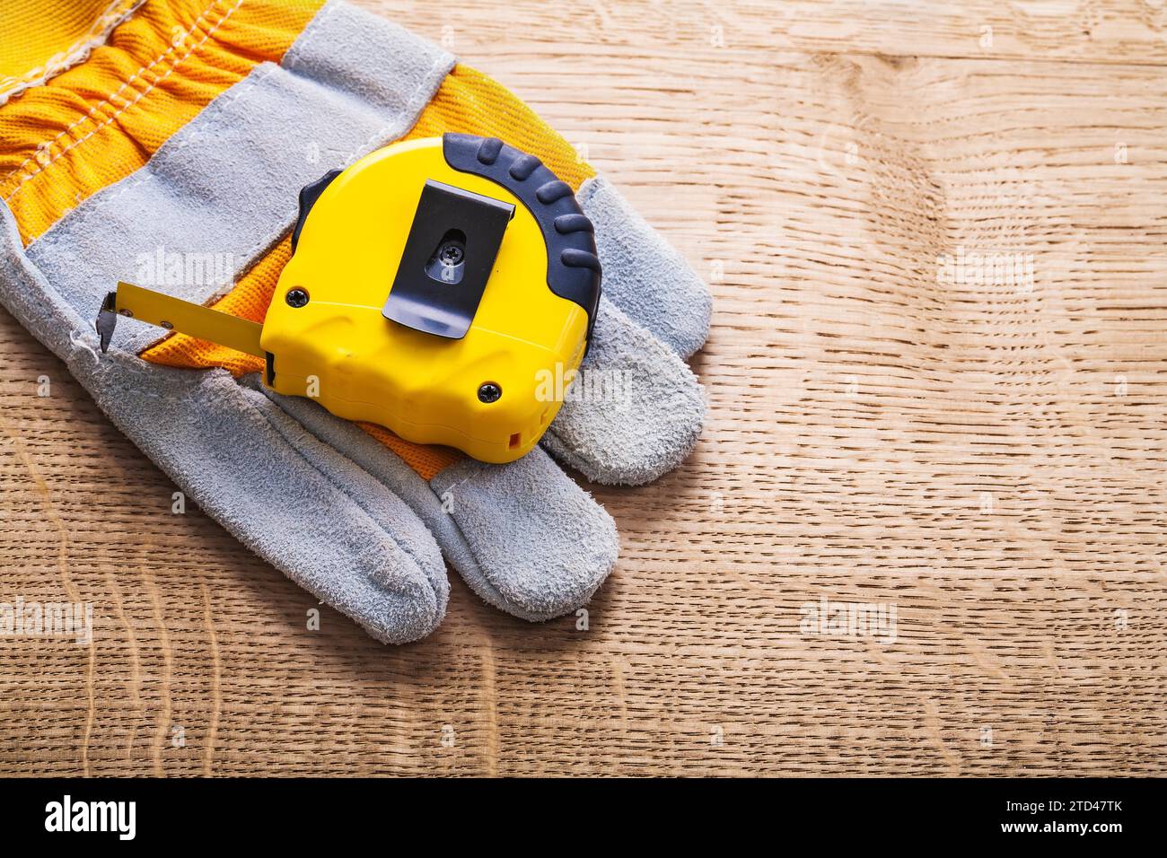 Horizontal design Belt line and safety glove on wooden panels Construction concept Stock Photo