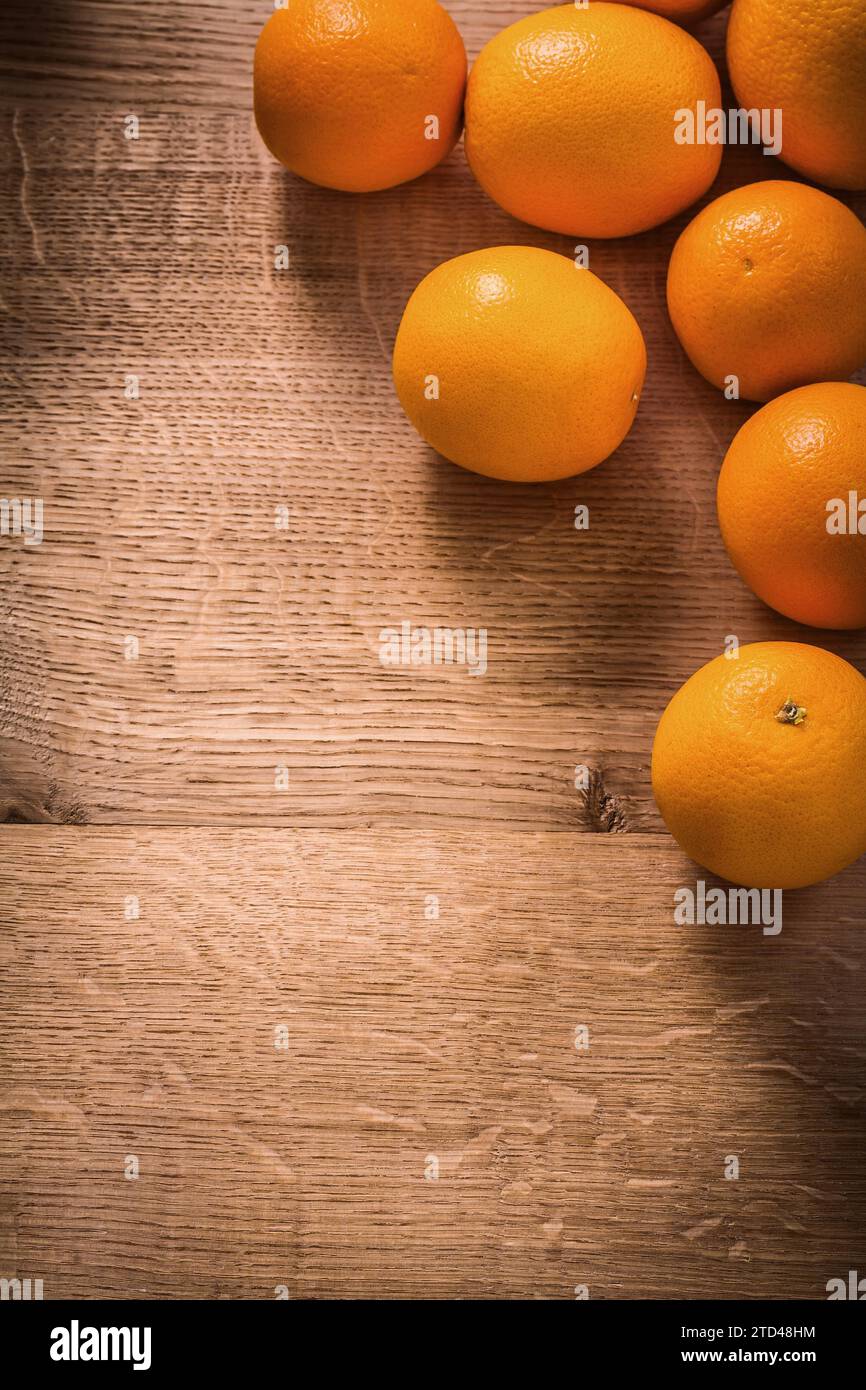Fresh ripe orange fruits on vintage wooden board with organised copyspace Stock Photo