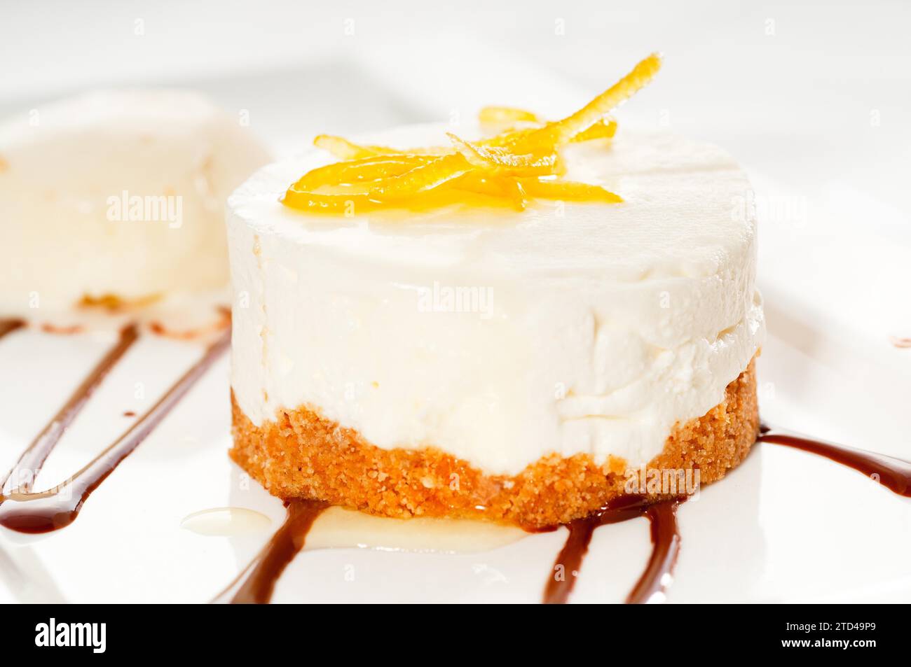 Very elegant lemon mousse dessert served whith lemon peel on top and ...