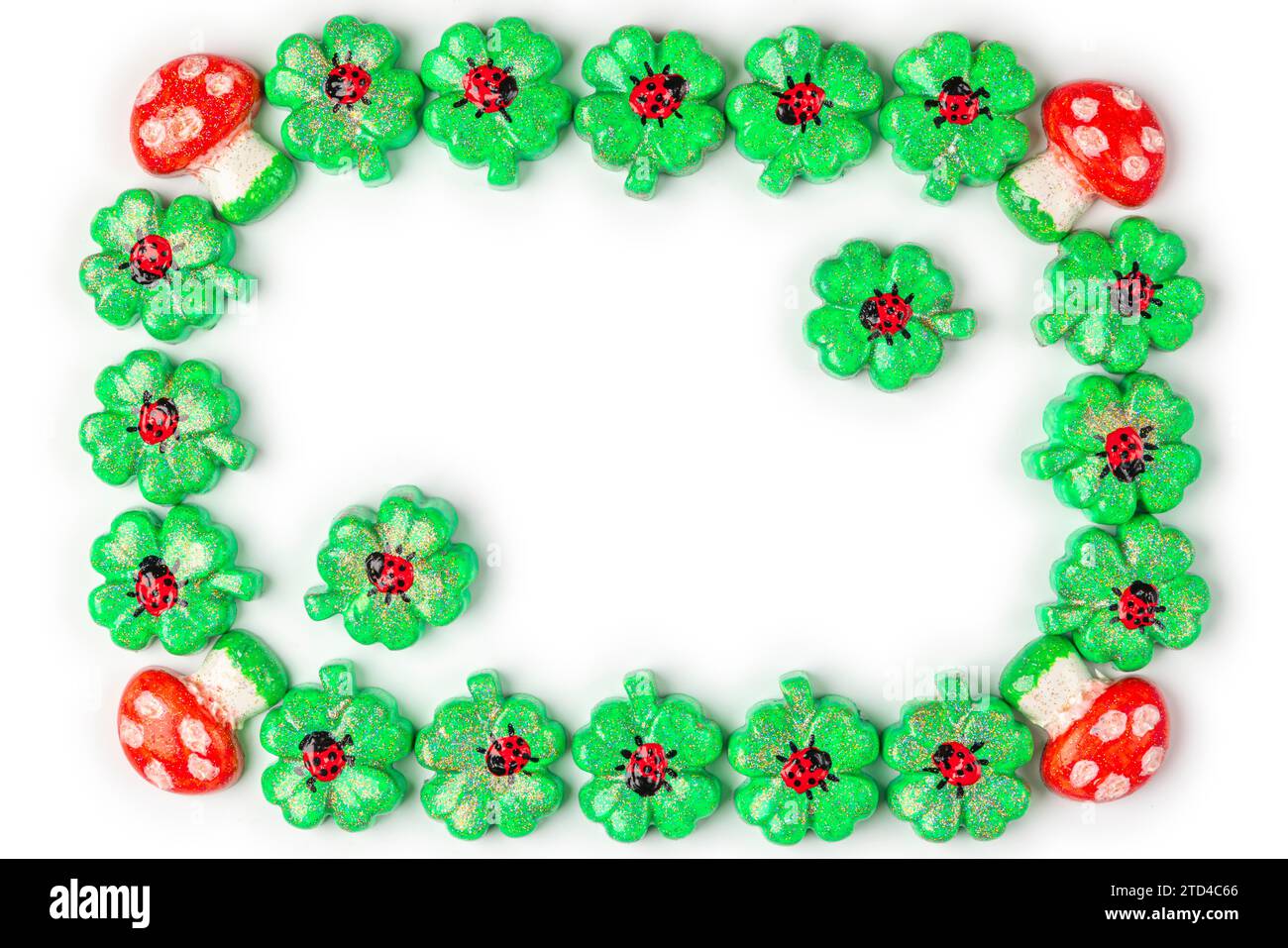 A frame of shamrocks with ladybirds and toadstools, lucky charms, on white, copy room Stock Photo