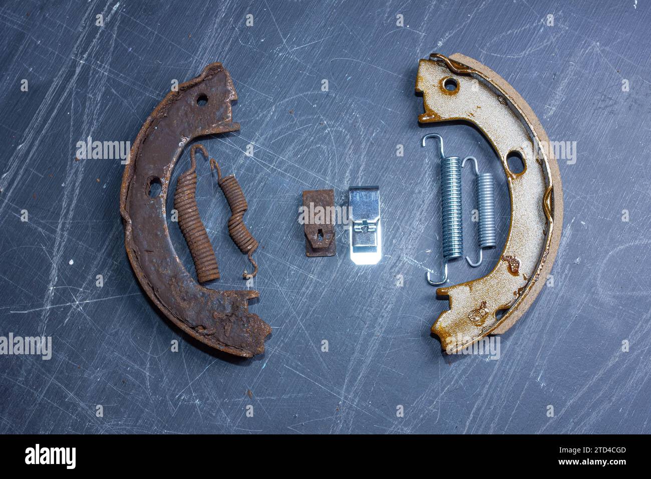 Hand parking brake pad replacement concept, old rusty auto parts are