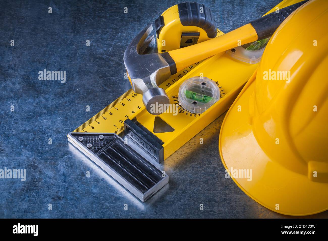 Measuring instruments Claw hammer and construction helmet on scratched