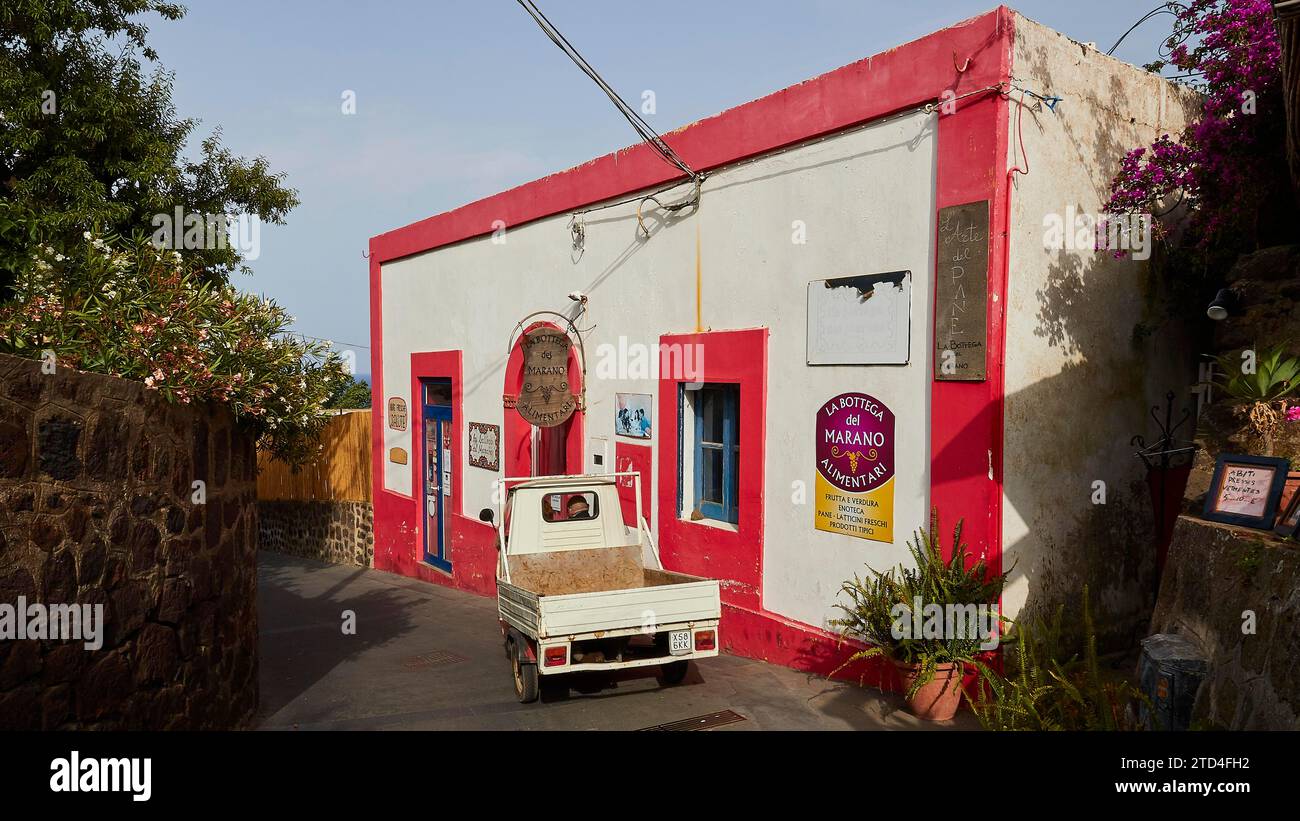 White Ape, motorised tricycle, red and white building, bar, volcanic island, Stromboli, Aeolian Islands, Lipari Islands, Sicily, Italy Stock Photo