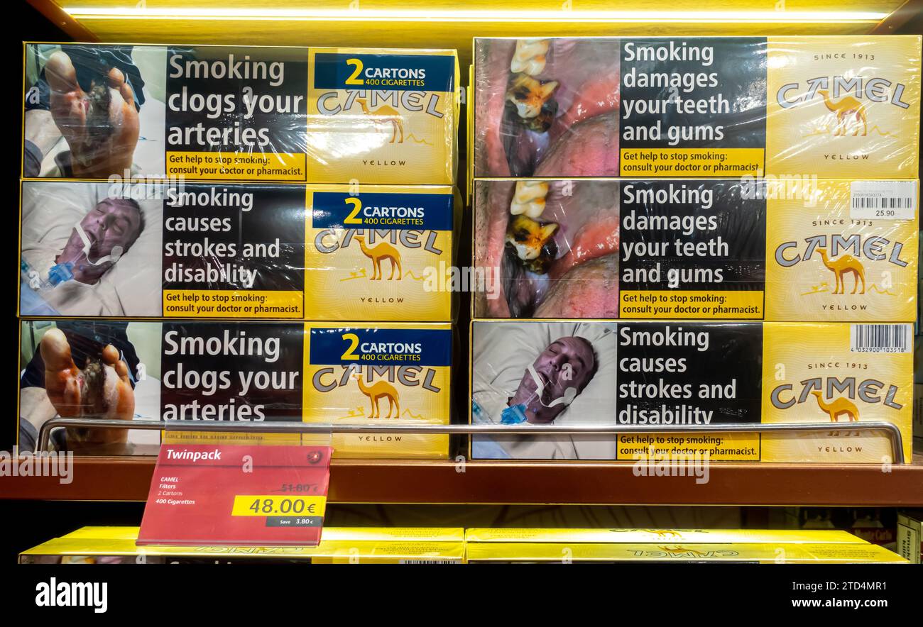 Camel cigarettes cartons with a price tag sold on the shelf in a duty free shop in Tbilisi Georgia. Warnings health hazards from tobacco smoking Stock Photo