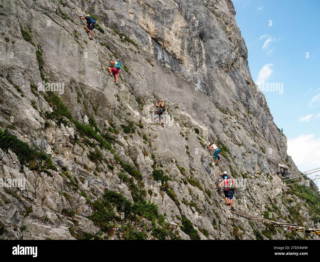 Mondsee and Attersee, Alps, Austria, Europe, Summer 2017: [ sky rope bridge and climbers climbing on rocky wall, view from Drachenwand rock, via ferra Stock Photo