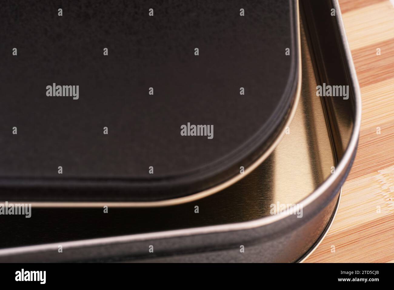 A close-up shot of an empty open black tin box of cookies. Stock Photo