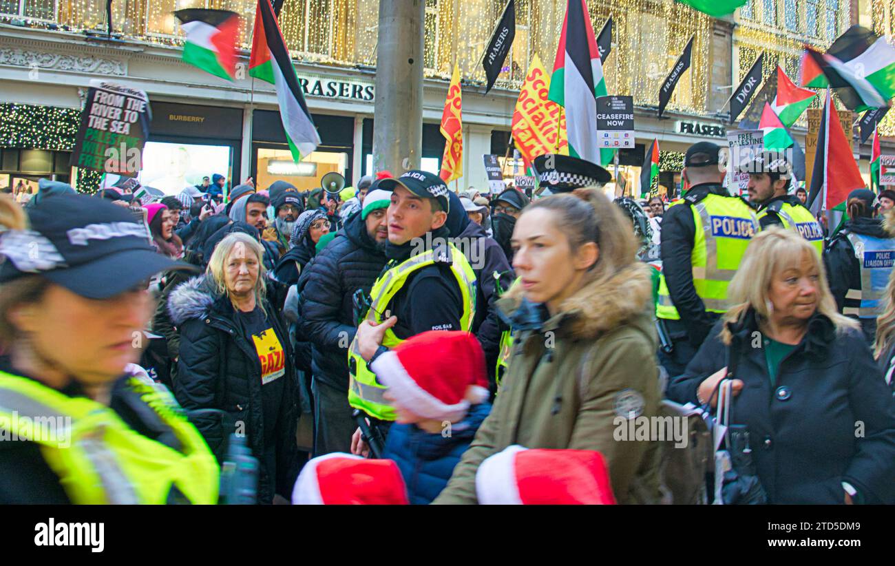 Glasgow, Scotland, UK.16th December, 2023.  Zara customers locked in as Palestinian protesters tool over Buchanan street the style mile and shopping capital of Scotland.  Police blockaded the door as customers were locked inside with others waiting to enter. The crowd moved on and customers were let out at 3.30pm. Credit Gerard Ferry/Alamy Live News Stock Photo