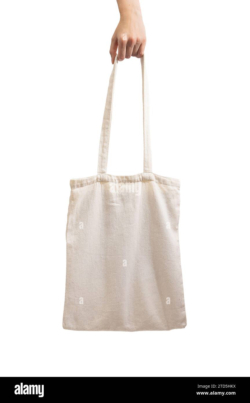 Hand holding tote bag, isolated on white background. Natural cloth shopper Stock Photo