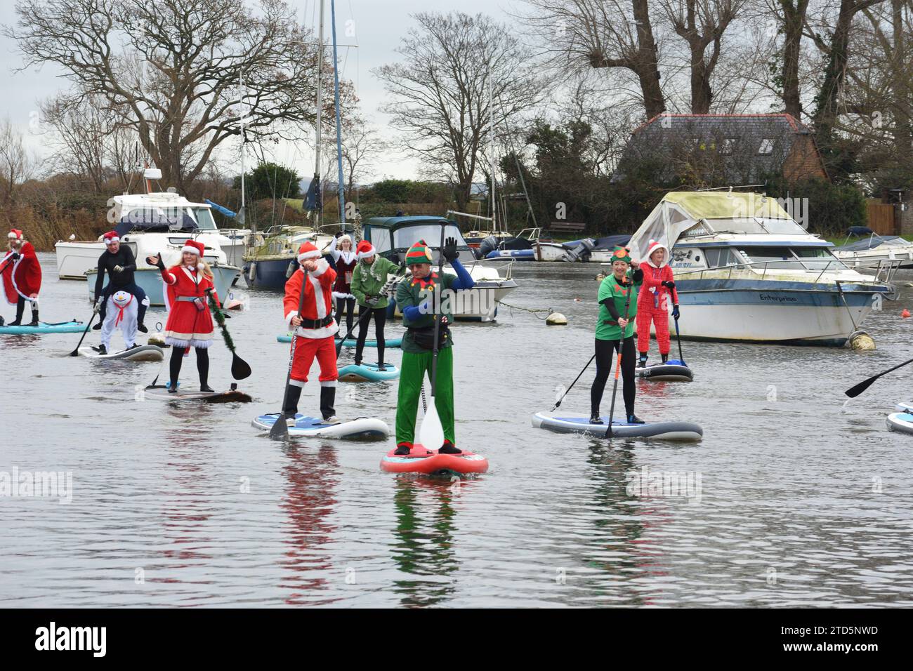 Paddle boarders dressed as Santa on the river Stour in Christchurch