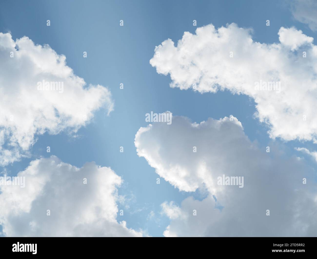 Sunlit white clouds in a summer sky Stock Photo