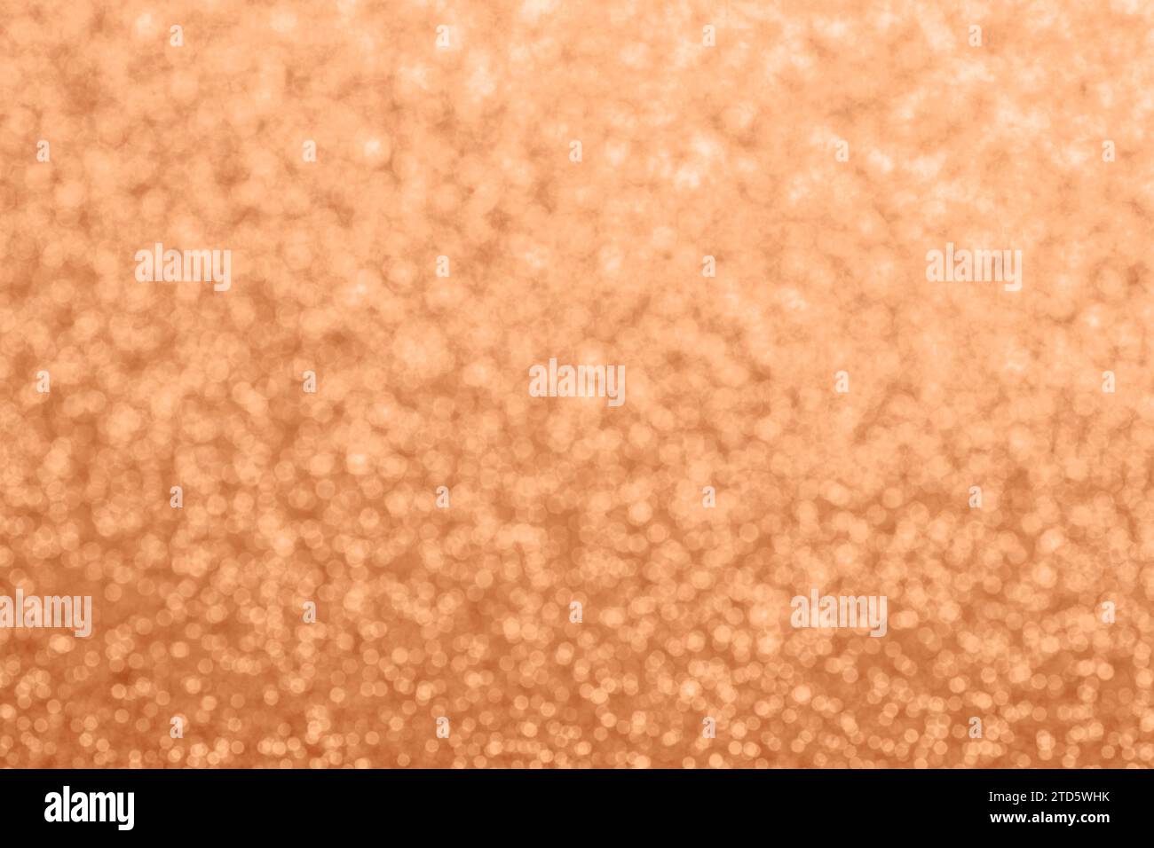 Abstract defocused glitter texture, background. Color of the year 2024 - Peach Fuzz. Copy space. Stock Photo