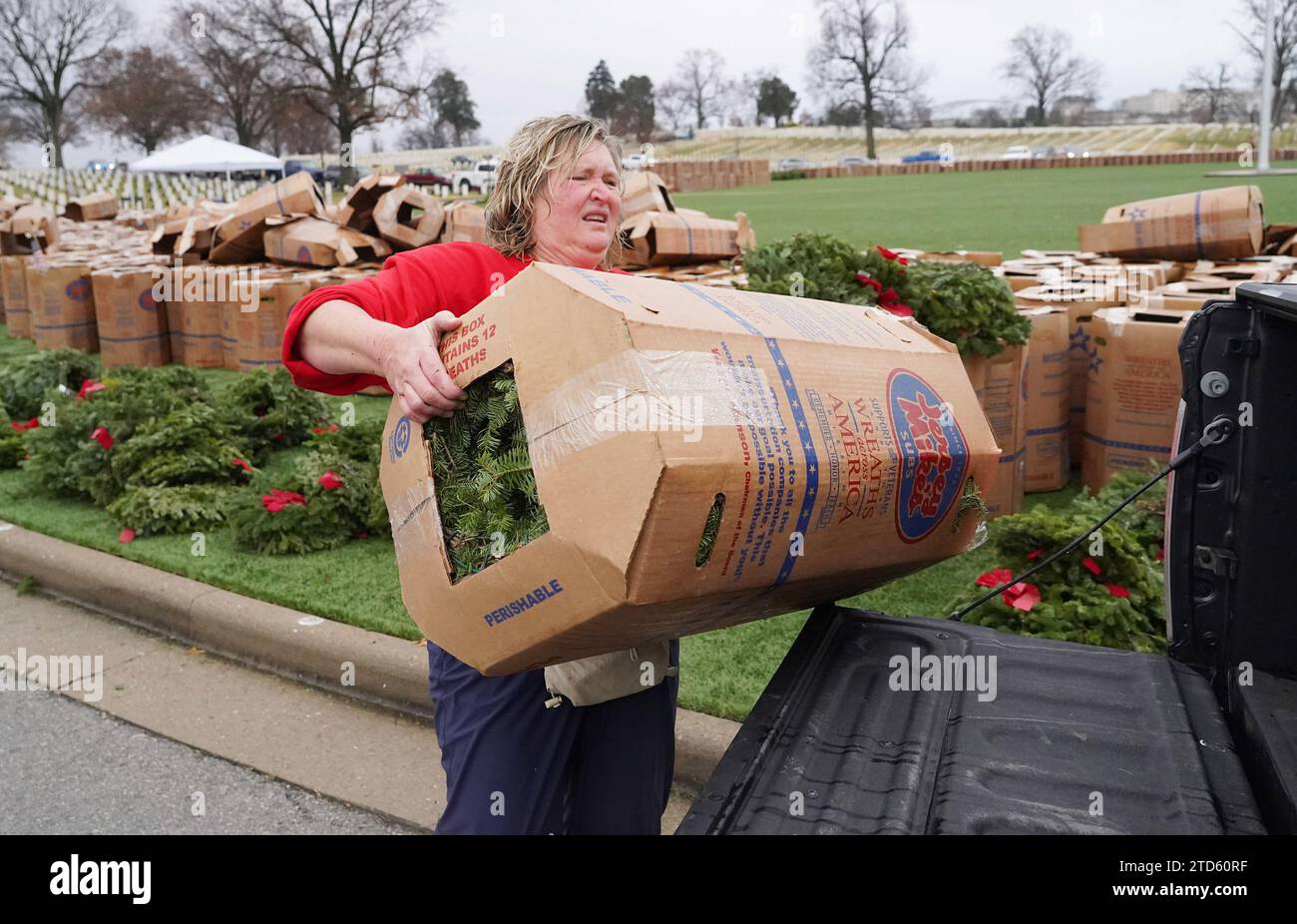 Volunteer Laura Pickerel places a box of wreaths into a waiting truck