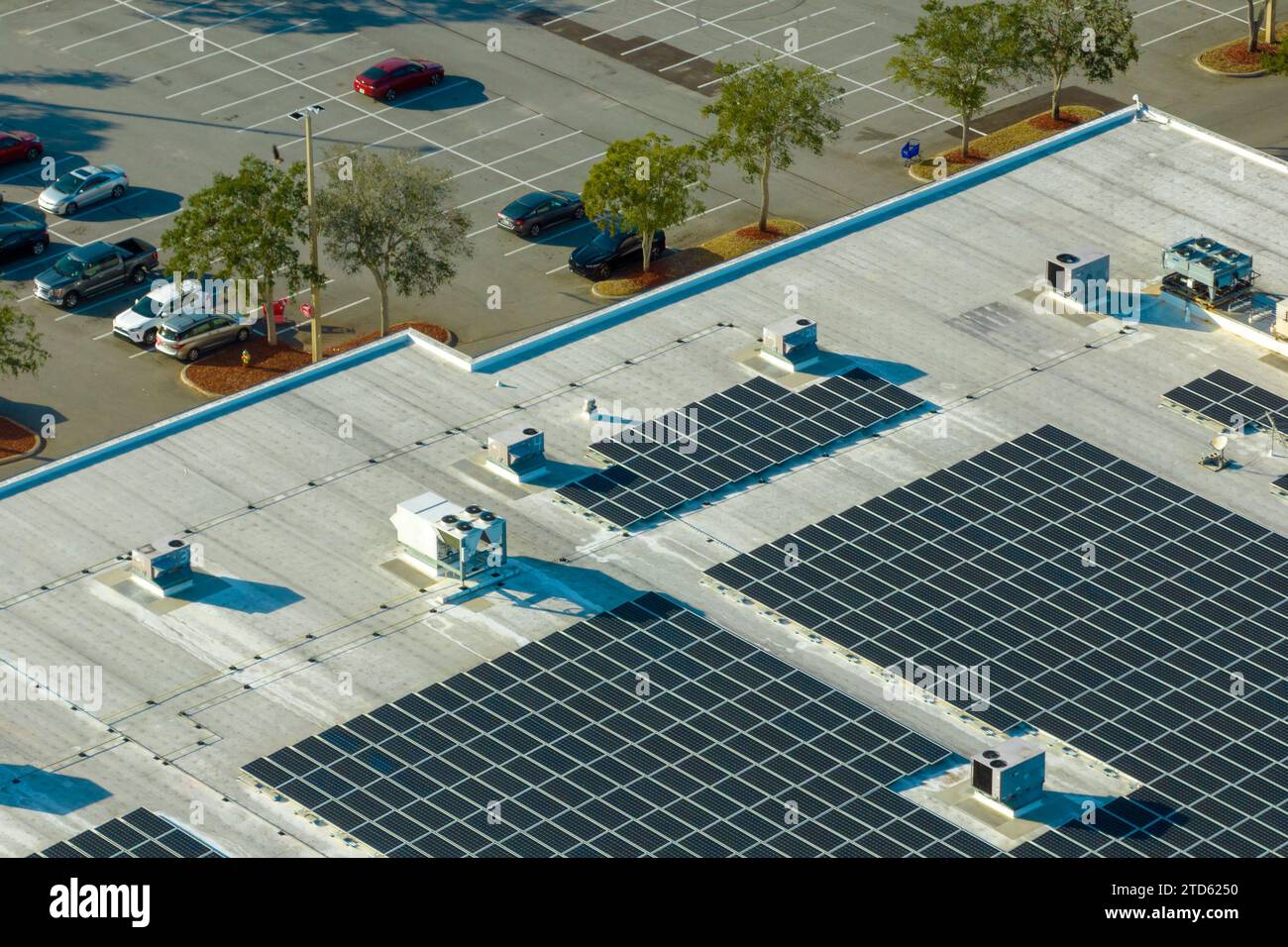 Aerial view of many photovoltaic panels installed on shopping mall roof ...