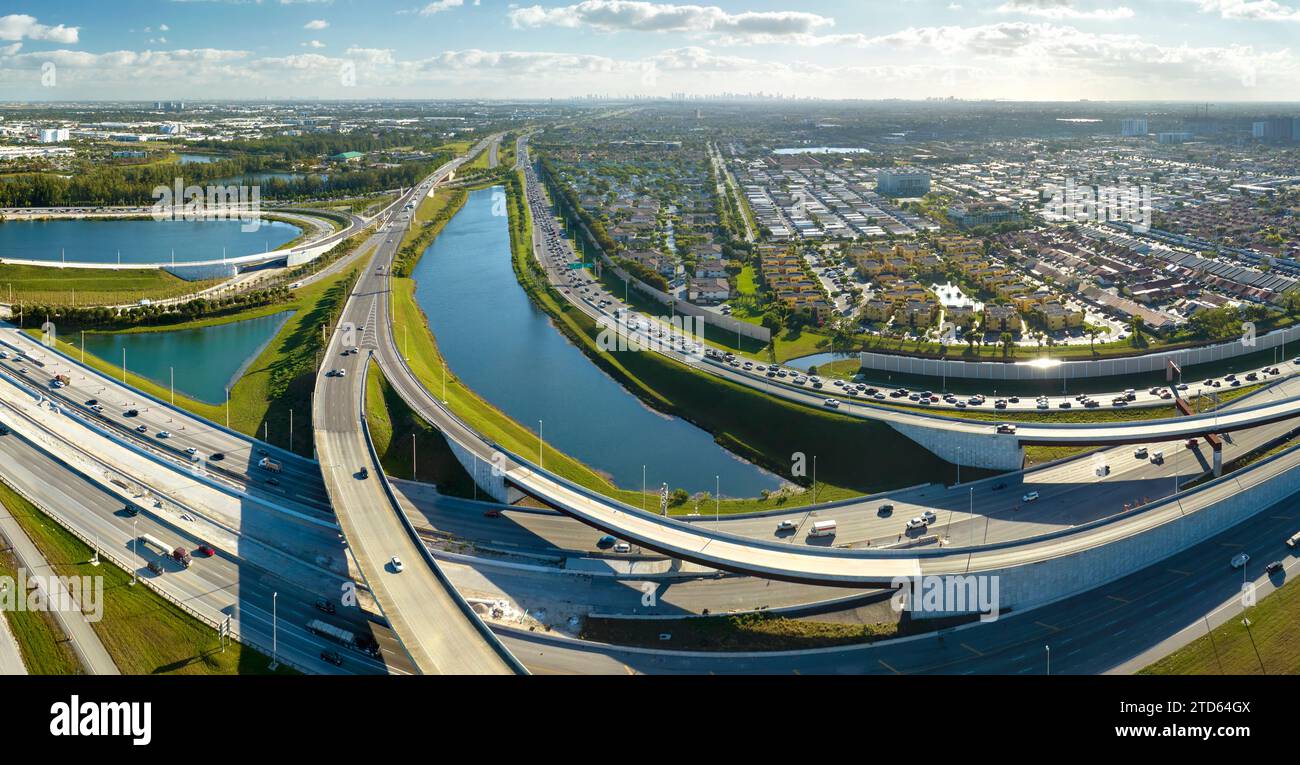 View from above of USA transportation infrastructure. Aerial view of american freeway intersection with fast driving cars and trucks in Miami, Florida Stock Photo