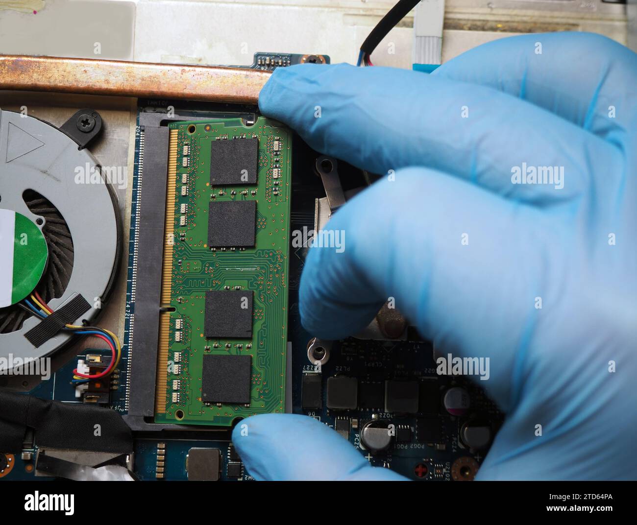 Technician inserting a ram module to the computer. Stock Photo