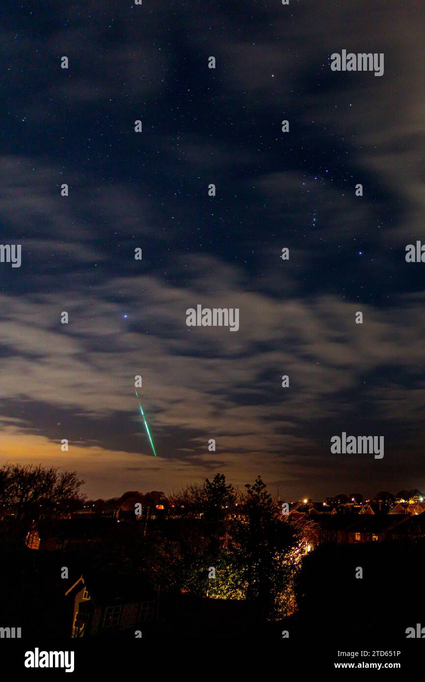 Geminid meteor over a housing estate, Buckley, North Wales Stock Photo