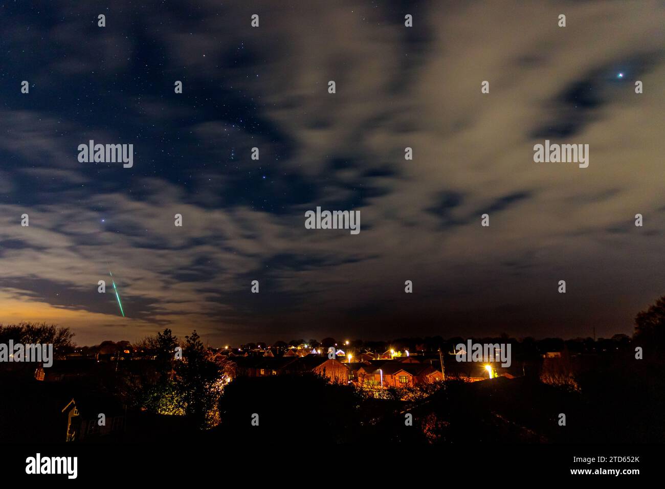 Geminid meteor over a housing estate, Buckley, North Wales Stock Photo