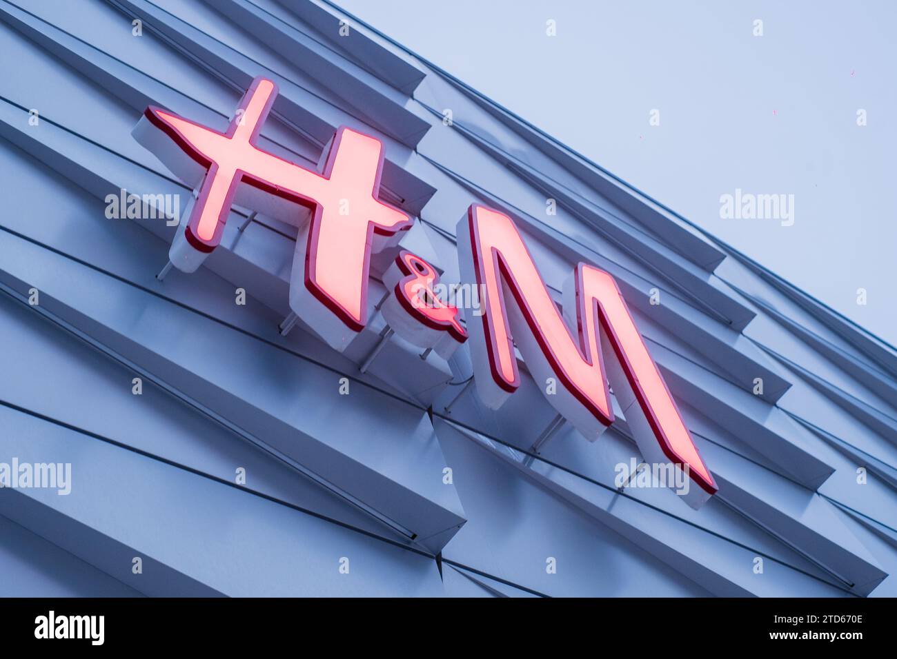 Tallinn, Estonia - December 16, 2023: H and M clothing store light sign. Stock Photo